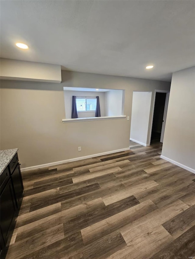 interior space with baseboards, dark wood-style flooring, and recessed lighting