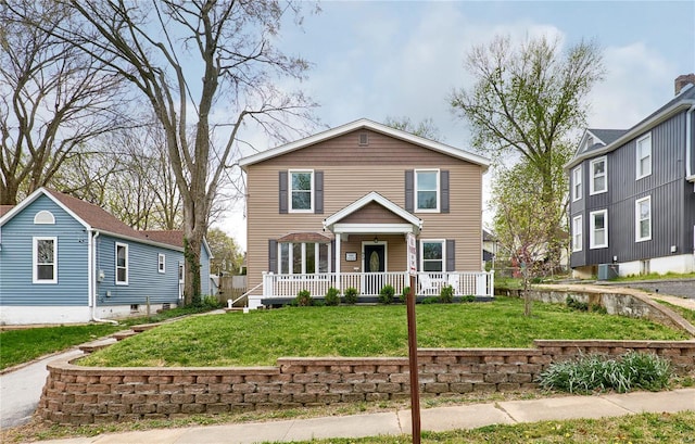 traditional-style home featuring central AC unit, a porch, and a front lawn