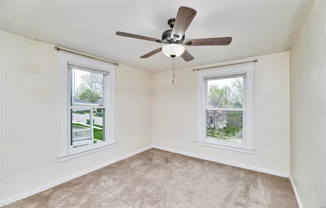 spare room featuring carpet floors, baseboards, and ceiling fan