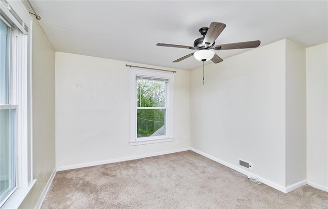 empty room with visible vents, baseboards, and carpet floors