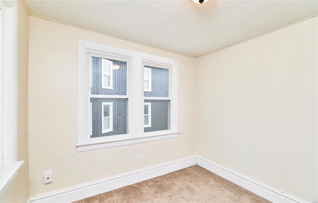 unfurnished room featuring carpet flooring and baseboards