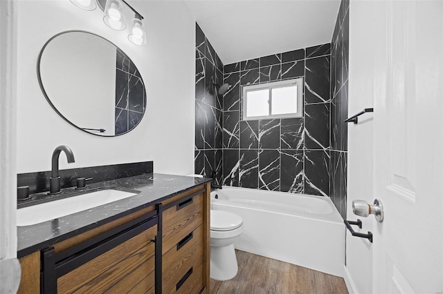 bathroom featuring toilet, shower / bath combination, vanity, and wood finished floors