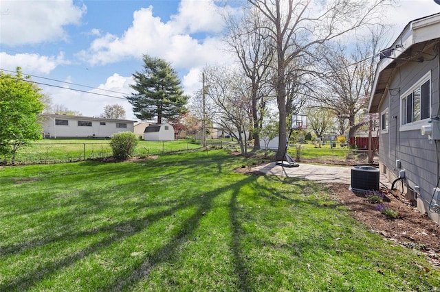 view of yard featuring a patio, central AC unit, and a fenced backyard