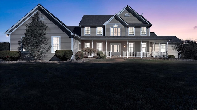 view of front of property with covered porch and a front yard