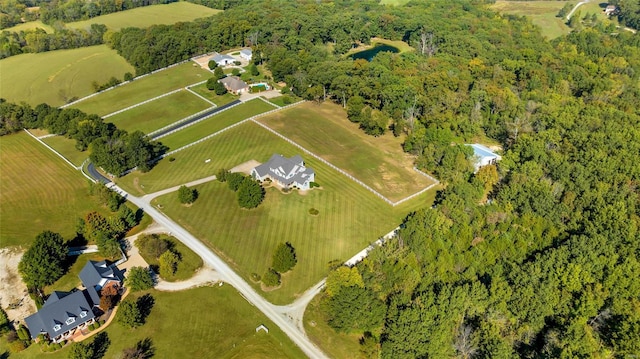 drone / aerial view featuring a wooded view and a rural view
