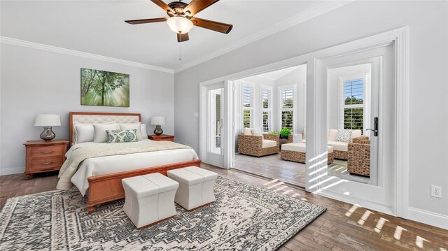 bedroom with access to exterior, crown molding, baseboards, and wood finished floors