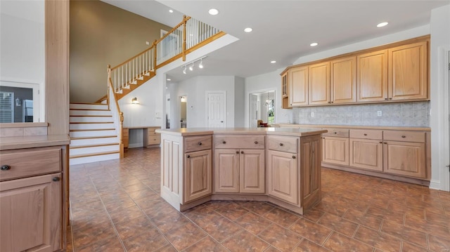 kitchen with light countertops, recessed lighting, a kitchen island, tasteful backsplash, and light brown cabinets