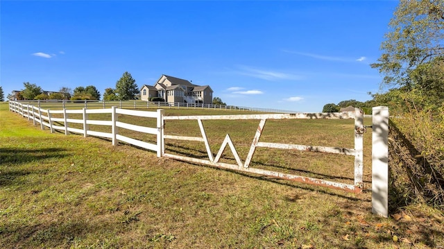 view of yard featuring fence and a rural view