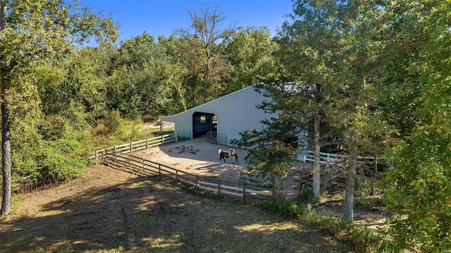 back of property featuring an exterior structure, a pole building, and an outdoor structure