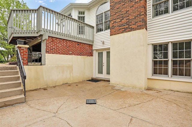 view of side of property with brick siding, french doors, and a patio area