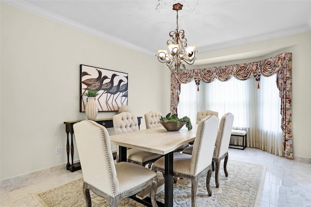 dining space with ornamental molding, marble finish floor, and an inviting chandelier