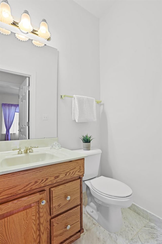 half bathroom with vanity and toilet