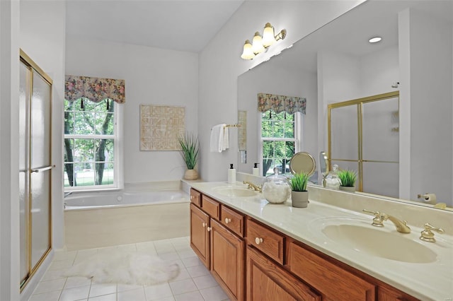 full bathroom featuring a shower stall, tile patterned flooring, a bath, and a sink