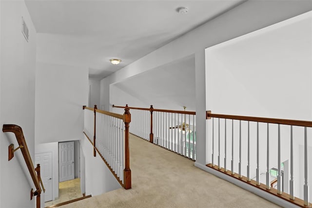 corridor featuring an upstairs landing, carpet, and visible vents