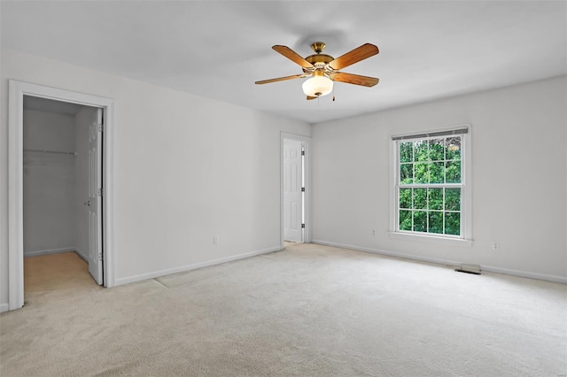 unfurnished bedroom with visible vents, baseboards, carpet, and a spacious closet