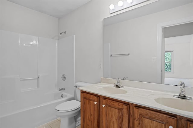 full bath with toilet, tile patterned flooring, double vanity, and a sink
