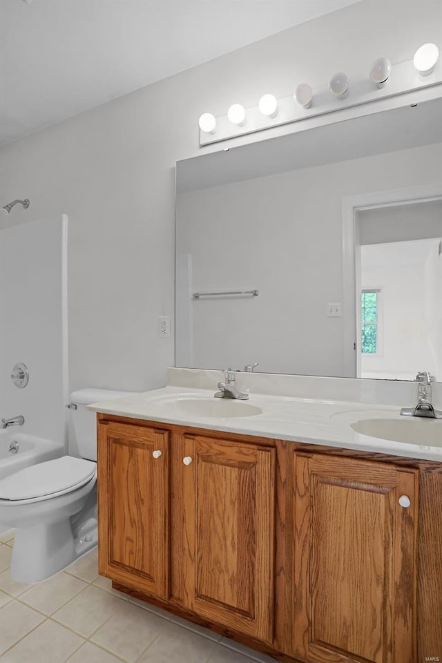 full bath featuring tile patterned floors, toilet, double vanity, and a sink