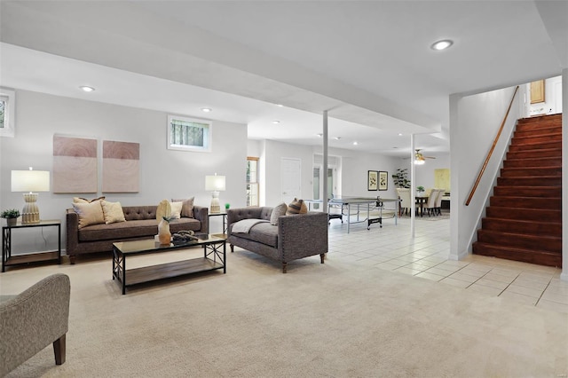 living room featuring recessed lighting, light tile patterned flooring, stairs, a ceiling fan, and light colored carpet