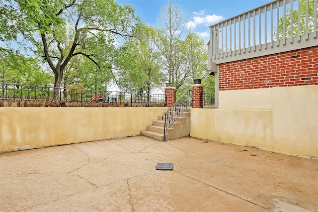 view of patio / terrace featuring stairs and fence