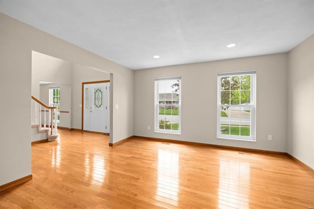 entryway featuring light wood-style floors, recessed lighting, baseboards, and stairway