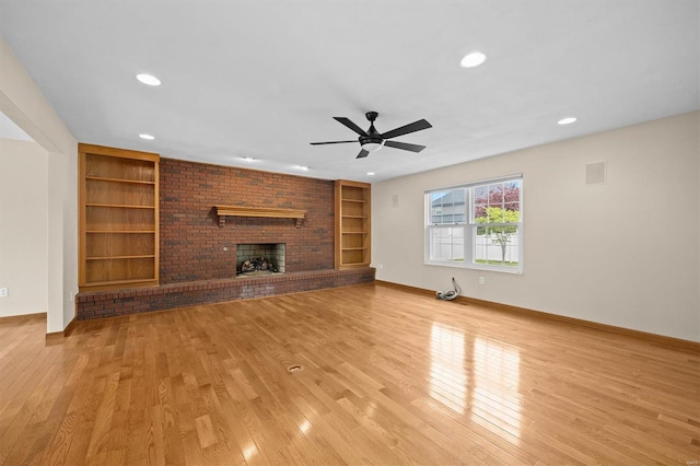 unfurnished living room with recessed lighting, ceiling fan, built in shelves, and light wood-style flooring