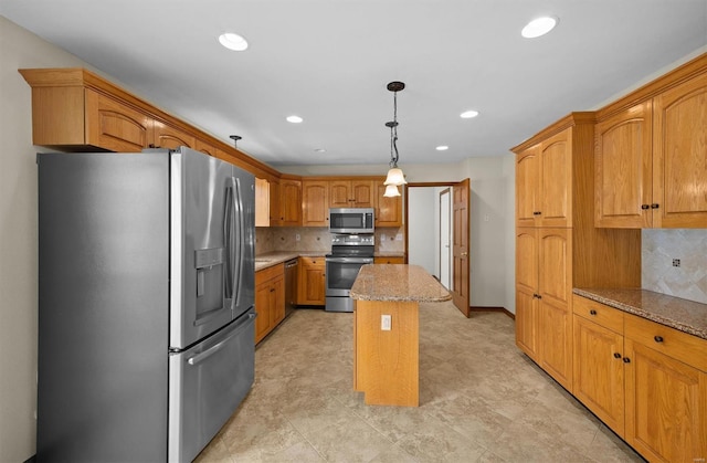 kitchen with light stone countertops, stainless steel appliances, decorative light fixtures, backsplash, and a kitchen island