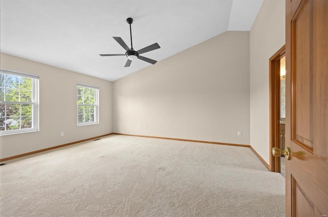 empty room featuring baseboards, light carpet, a ceiling fan, and lofted ceiling
