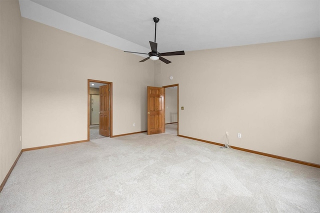 unfurnished bedroom featuring baseboards, light carpet, a ceiling fan, and high vaulted ceiling