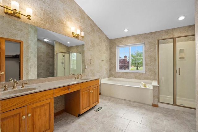 full bath with double vanity, a sink, a bath, and a stall shower