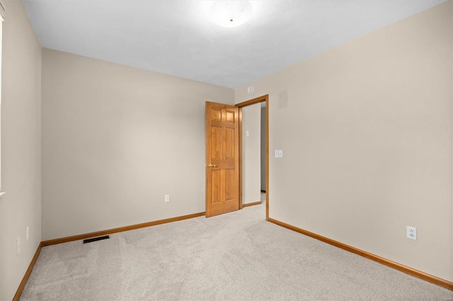 carpeted empty room with baseboards and visible vents