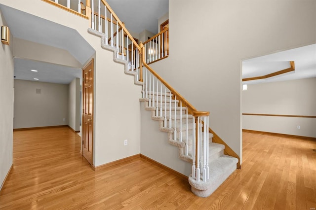 stairs with baseboards and wood finished floors