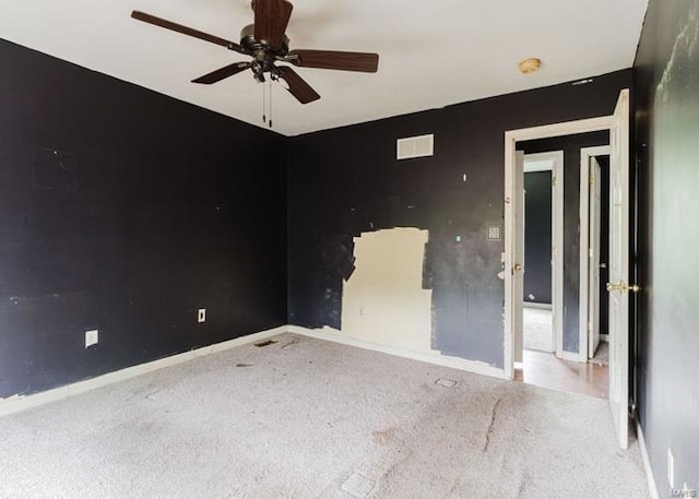unfurnished room with carpet flooring, baseboards, and ceiling fan