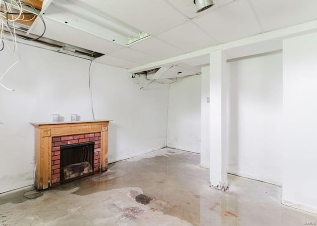finished basement with a brick fireplace