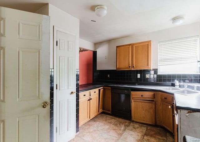 kitchen featuring a sink, tasteful backsplash, black dishwasher, brown cabinets, and dark countertops