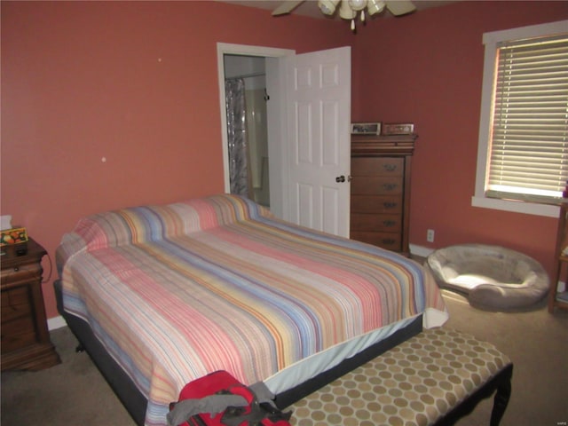 bedroom featuring baseboards, a ceiling fan, and carpet
