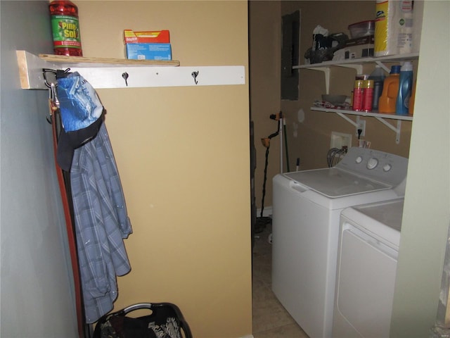 clothes washing area with electric panel, independent washer and dryer, and laundry area