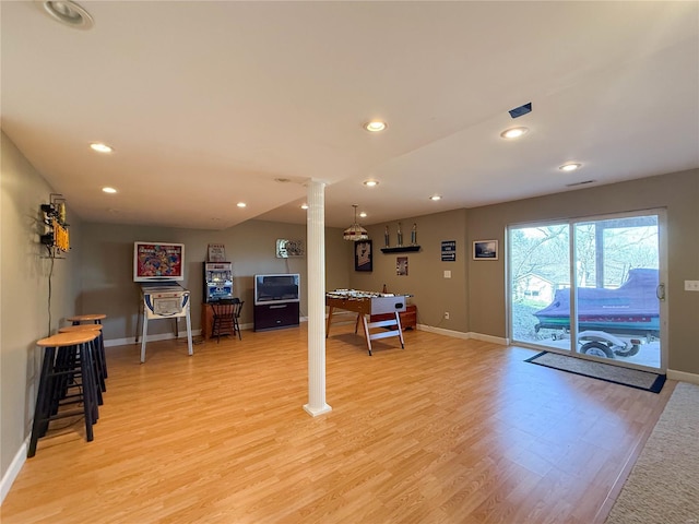 interior space with recessed lighting, baseboards, ornate columns, and light wood-type flooring