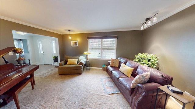 living room featuring crown molding, baseboards, rail lighting, and light carpet