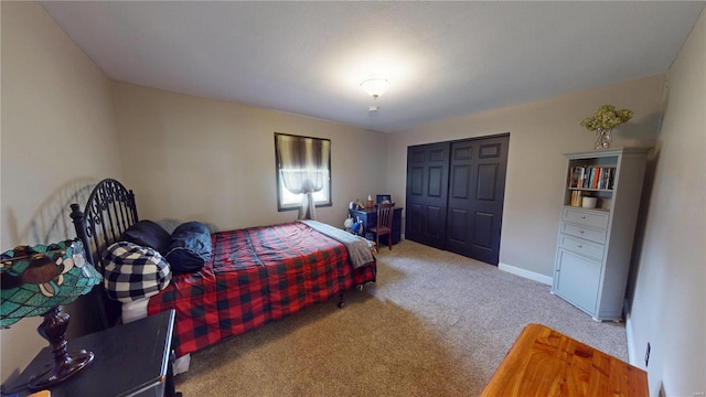 bedroom with a closet, baseboards, and carpet