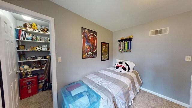 bedroom with carpet, visible vents, and baseboards