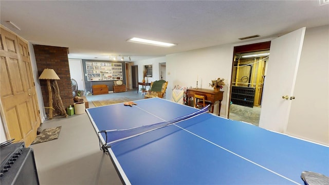 game room with concrete floors, visible vents, and radiator