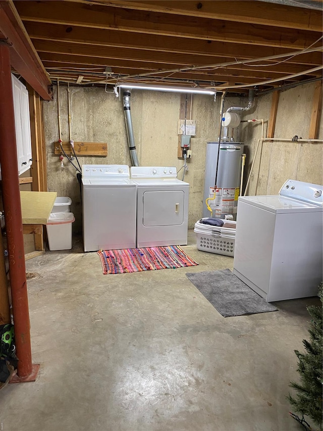 unfinished basement featuring gas water heater and washing machine and dryer