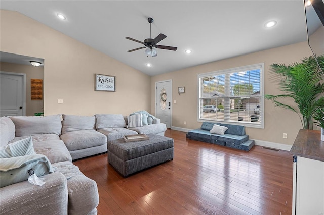 living area featuring visible vents, baseboards, ceiling fan, hardwood / wood-style floors, and lofted ceiling