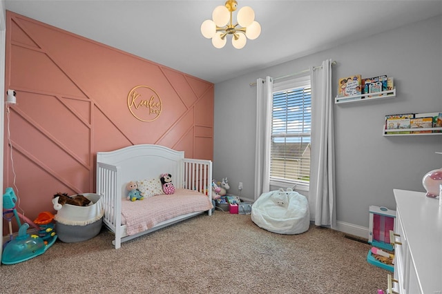 carpeted bedroom featuring visible vents, baseboards, and an inviting chandelier