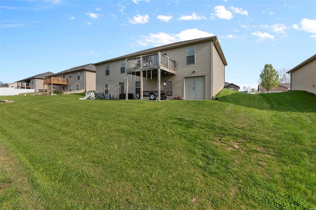 rear view of property with a yard and a deck