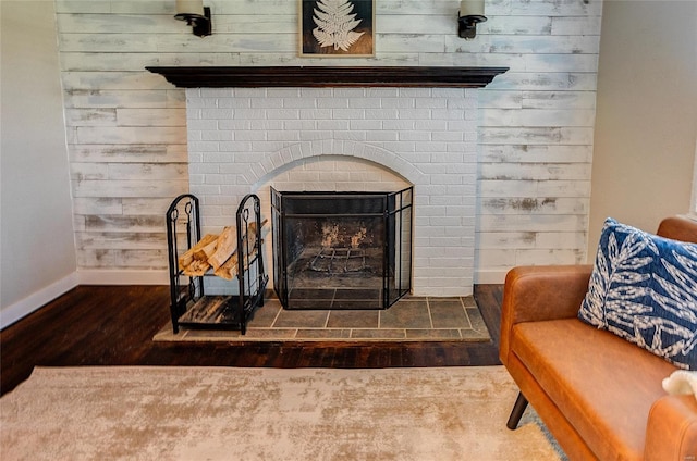 details with wood finished floors, a fireplace, and baseboards