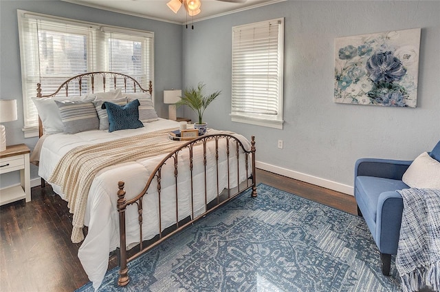 bedroom featuring baseboards, multiple windows, and wood finished floors