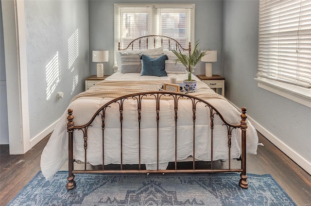 bedroom featuring wood finished floors and baseboards