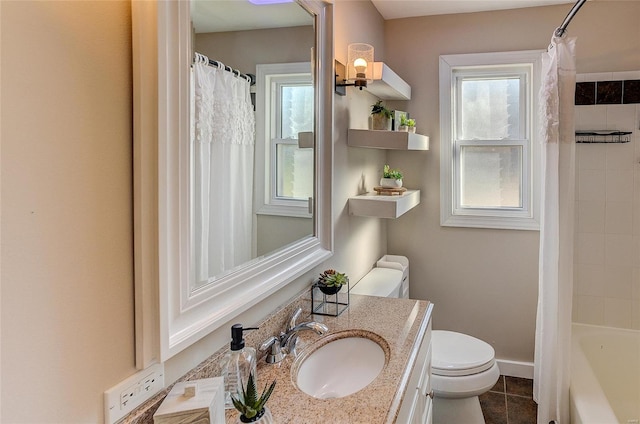 full bathroom featuring toilet, vanity, baseboards, and tile patterned flooring