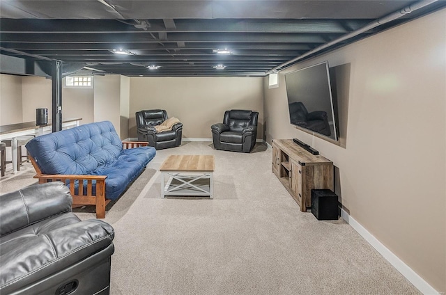 carpeted living area with baseboards